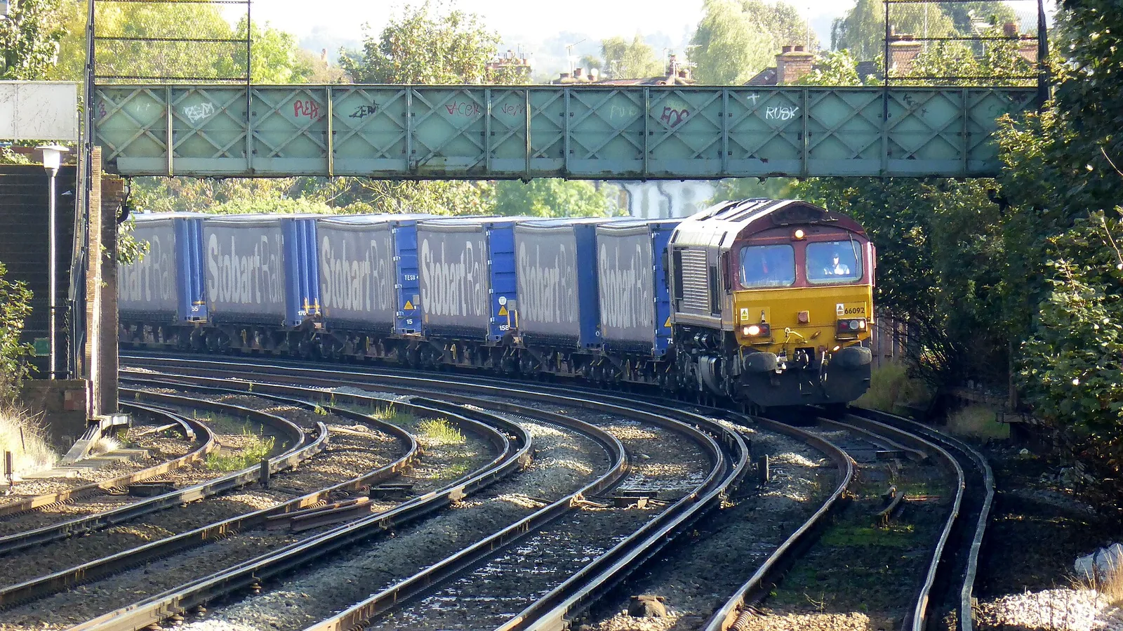 DB Schenker Rail (UK) Ltd's class 66 (JT42CWR) number 66092 in English, Welsh and Scottish Railway maroon livery with zigzag gold band, larg