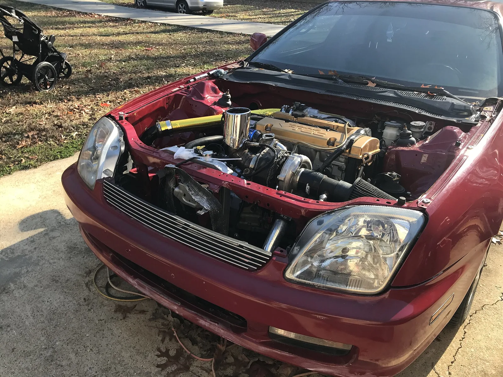 The engine bay of a modified turbo Honda prelude with an f20b