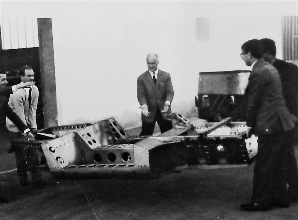 Lifting an automobile frame which was probably intended for the Lamborghini P400 Miura prototype made in 1965. In the middle: Carlo Anderlo