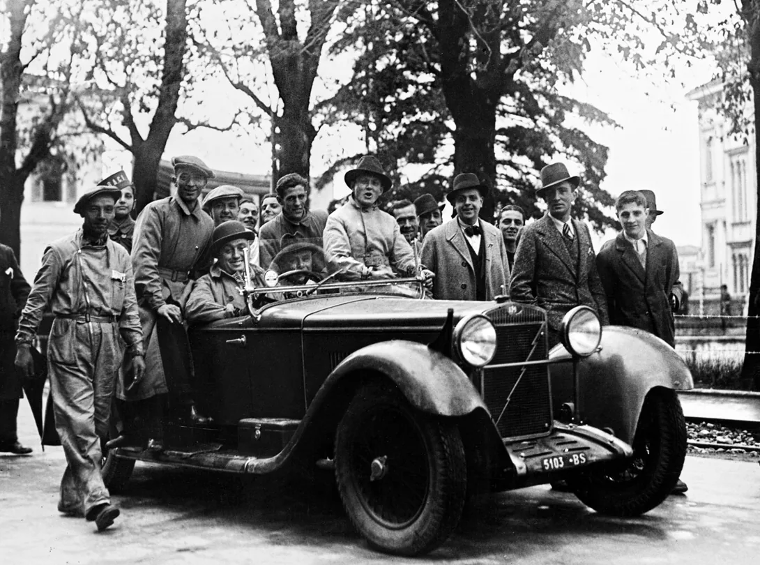 OM 665 Superba and people. Once captions says: "Renzo Castagneto behind the wheel of a 665 O.M. at the event he helped create, the Mille Mig
